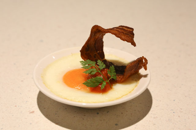 Baked egg with crispy bacon and truffle oil